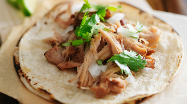 authentic mexican tacos with carnitas, cilantro and onion