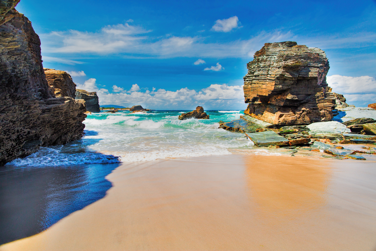 View of the ocean between rocks of Praia de Augas Santas.