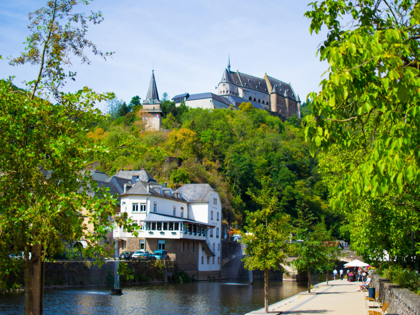 Vianden Castle on a hill with houses and Our river in Vianden, Luxembourg