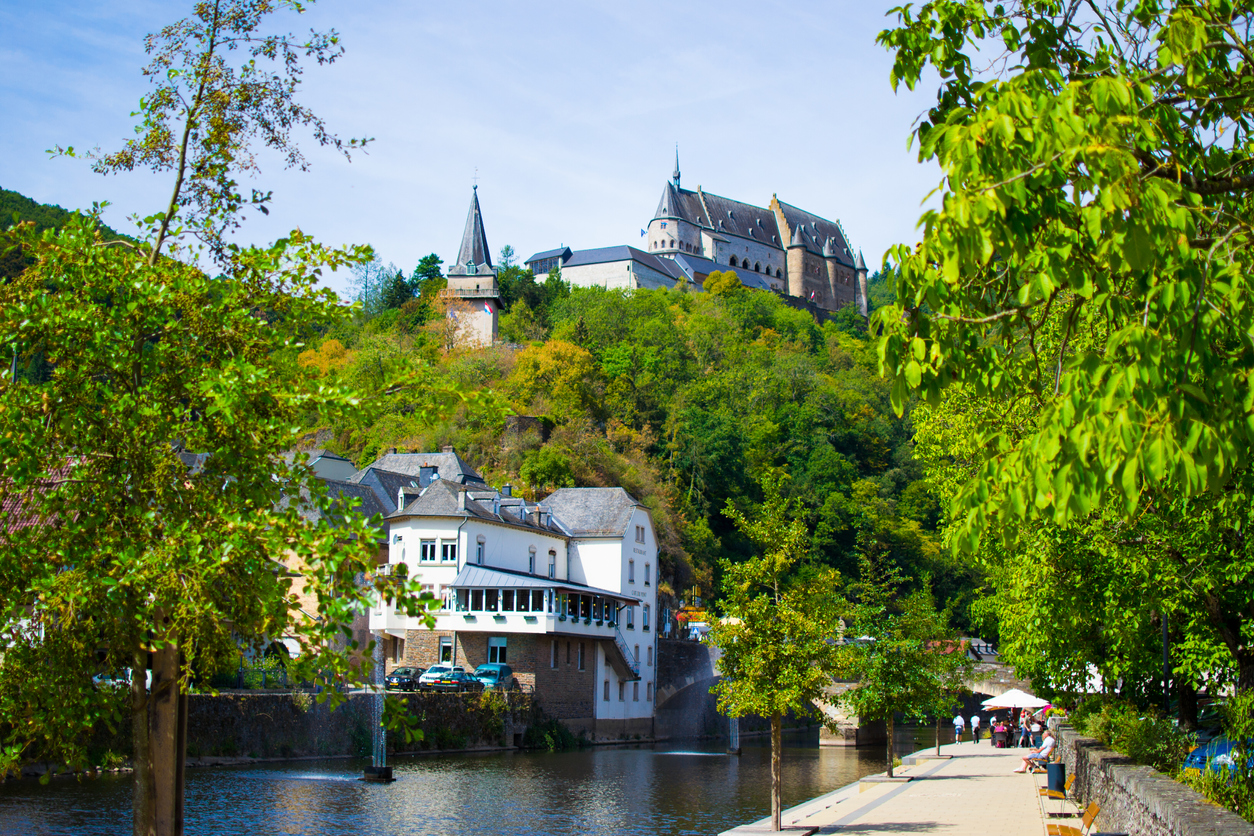 Vianden Castle on a hill with houses and Our river in Vianden, Luxembourg