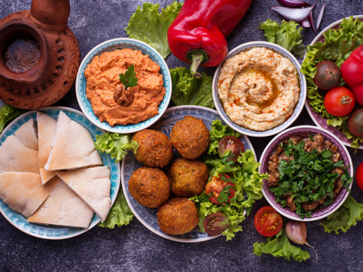 Selection of Middle eastern or Arabic dishes. Falafel, hummus, pita and  muhammara. Top view