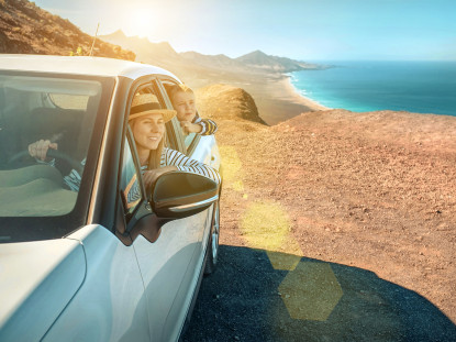 Happiness mother and son, sitting in white car and look on the beautiful ocean coastline view. Freedom, Family, Travel, Journey, Togetherness concept.